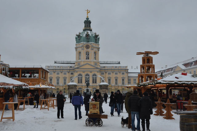 Charlottenburg Castle and the Christmas market after a snowfall.
