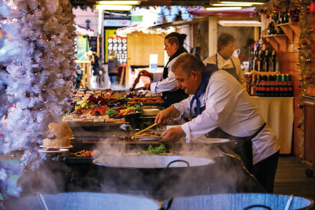 The cooks prepare Hungarian goulash at a Christmas market stall in Budapest.