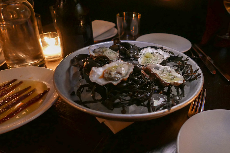 Oysters on a table with low lights at Noble Rot restaurant in Soho