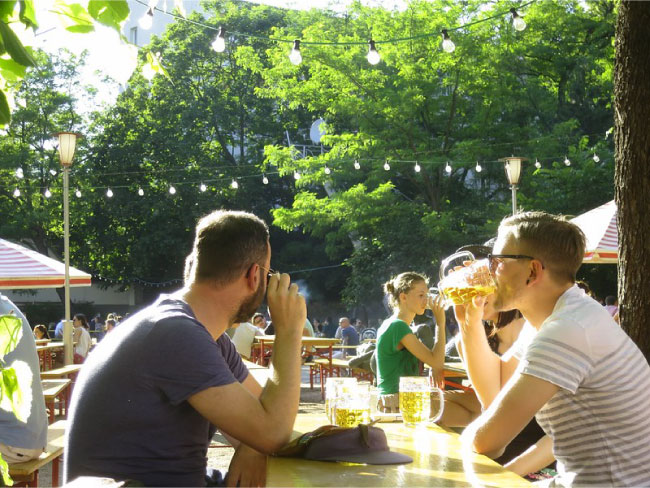 Boys drink beer on a sunny day at the Prater Biergarten, Berlin's oldest beer garden.